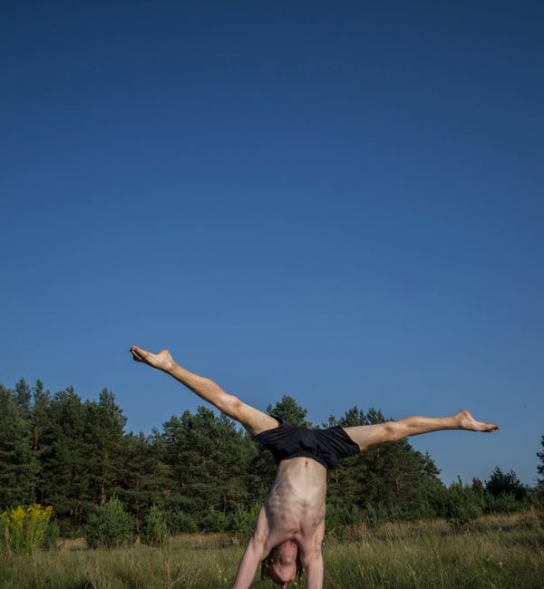 Person demonstrating a yoga pose that highlights physical strength and stability.